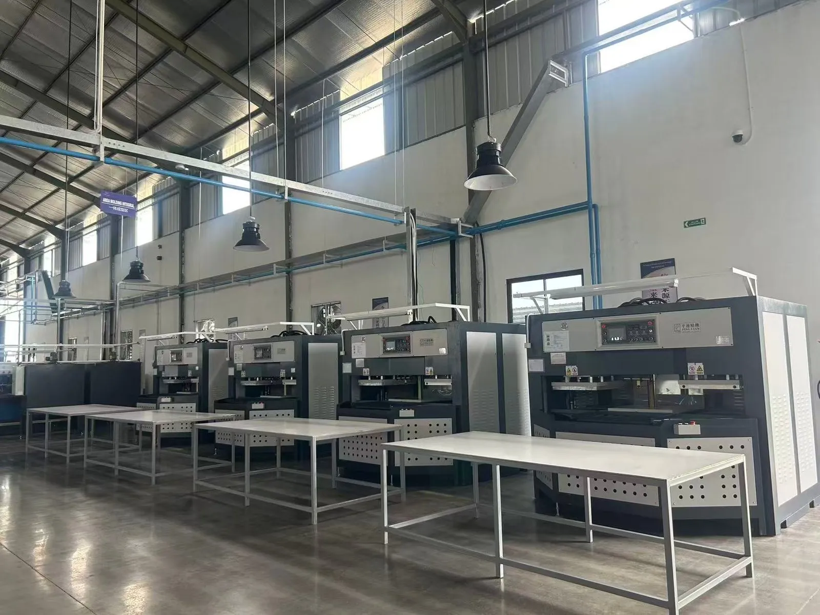 Hot and cold press molding machines on the production floor
